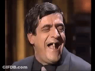 Man In Suit And Tie With Missing Tooth GIF