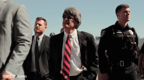 Man In Suit And Tie With N On Shirt GIF