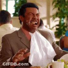 Man In Suit And Tie With Napkin Around Mouth GIF