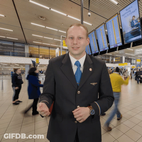 Man In Suit And Tie With Reis U Sign GIF