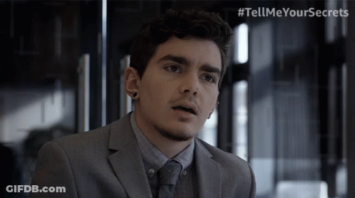 Man In Suit And Tie With Tell Me Your Secrets Hashtag GIF