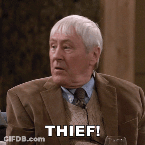 Man In Suit And Tie With Thief On Face GIF