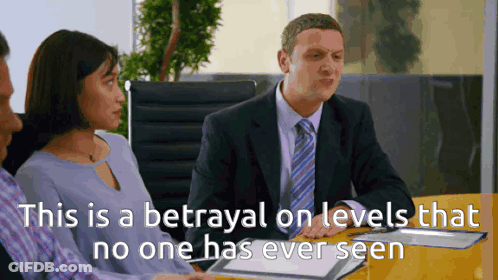 Man In Suit And Tie With Woman And Man In Blue Shirts GIF