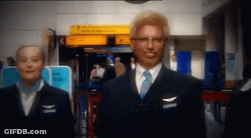 Man In Suit And Tie With Woman In Blue Uniform GIF