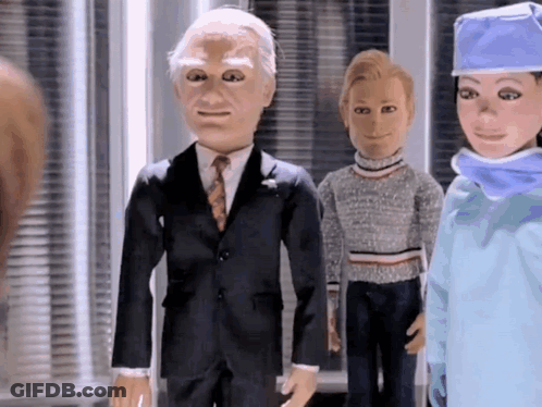 Man In Suit And Tie With Woman In Surgical Cap GIF