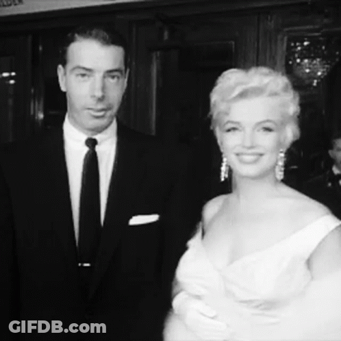 Man In Suit And Tie, Woman In Dress GIF