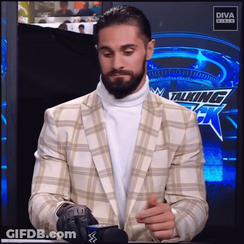 Man In Suit And Turtleneck At Diva Studios Sign GIF