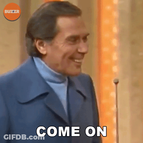 Man In Suit And Turtleneck Smiling Saying Come On GIF