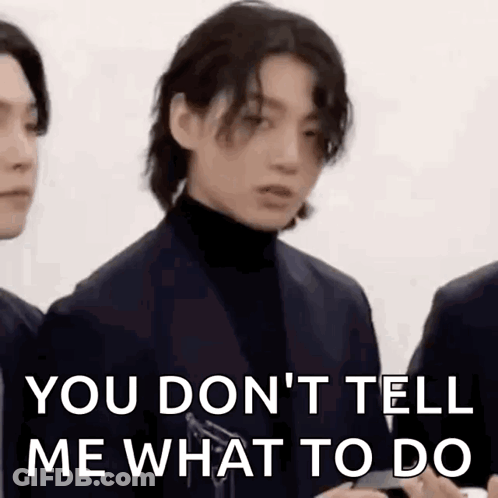 Man In Suit And Turtleneck Standing Next To Another Man GIF