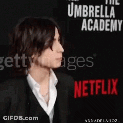 Man In Suit And White Shirt At Netflix Sign GIF