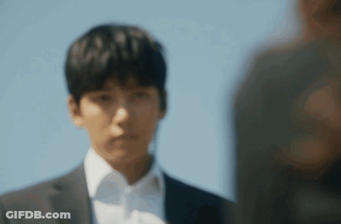 Man In Suit And White Shirt Looks At Another Man GIF