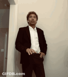 Man In Suit And White Shirt Standing Hallway GIF