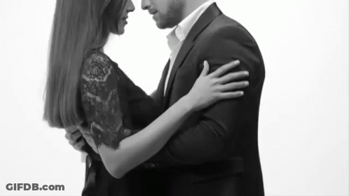 Man In Suit And Woman In Black Dress Hugging GIF