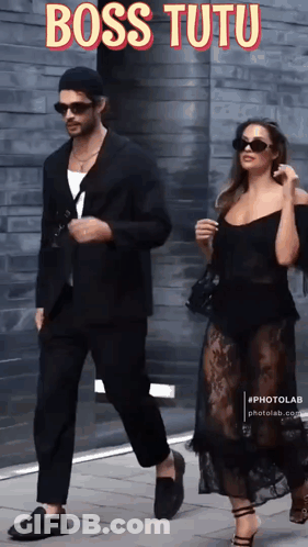 Man In Suit And Woman In Black Dress Walking Down Sidewalk Boss Tutu GIF
