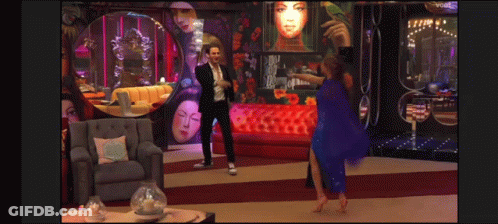 Man In Suit And Woman In Blue Dress Dancing In Living Room GIF