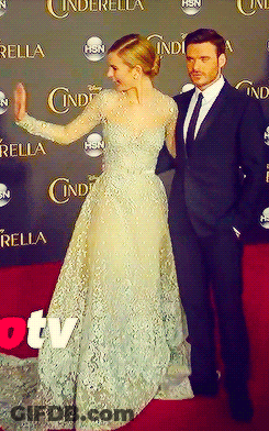Man In Suit And Woman In Dress On Cinderella Red Carpet GIF
