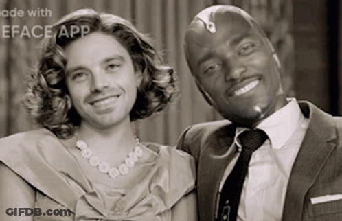 Man In Suit And Woman In Dress Smiling GIF