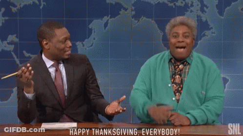 Man In Suit And Woman In Green Cardigan Sitting GIF