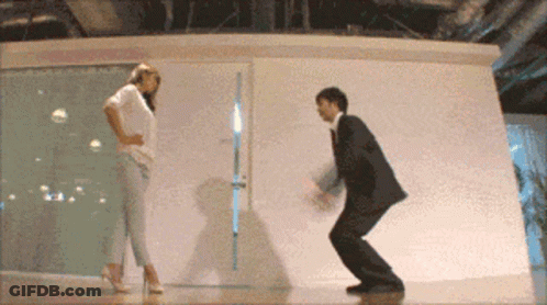 Man In Suit And Woman In High Heels Dancing GIF