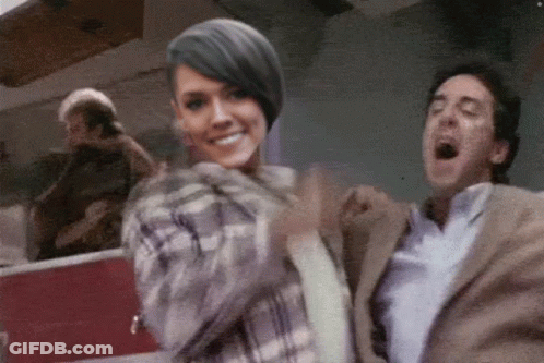 Man In Suit And Woman In Plaid Shirt Standing Together GIF