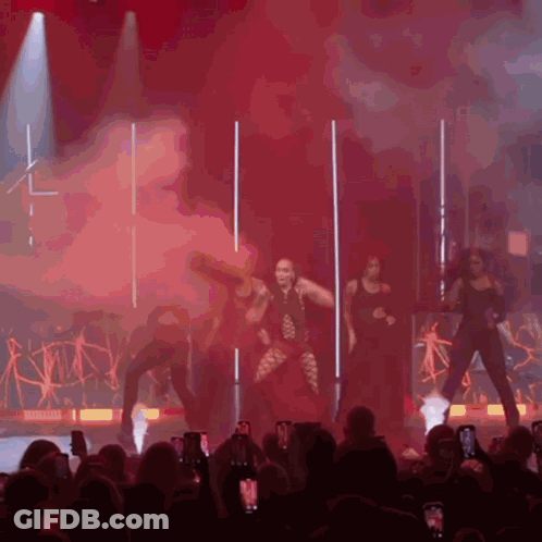 Man In Suit And Woman In Red Dress In Front Of Denver Sign GIF