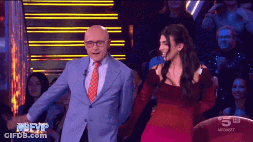 Man In Suit And Woman In Red Dress On TV Saying 5 HD GIF