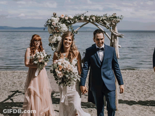 Man In Suit And Woman In Wedding Dress Smiling GIF