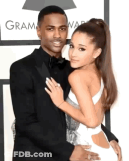 Man In Suit And Woman In White Dress At Grammy Awards GIF