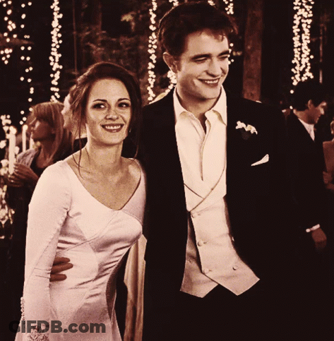 Man In Suit And Woman In White Dress Smile GIF