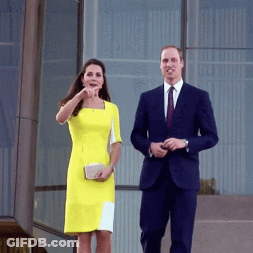Man In Suit And Woman In Yellow Dress Walking GIF
