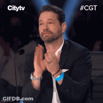 Man In Suit Applauding At Microphone GIF