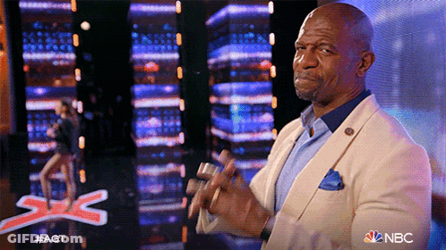 Man In Suit Applauding In Front Of NBC Sign GIF