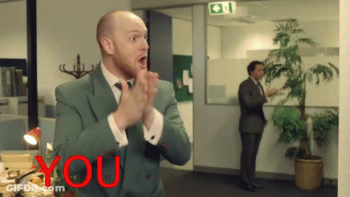 Man In Suit Applauding In Front Of Sign Saying You GIF