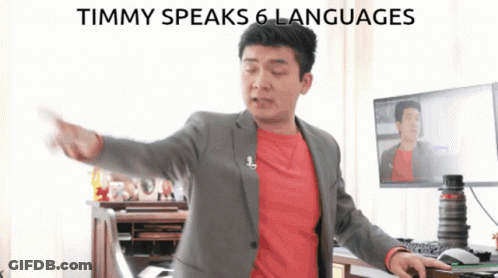 Man In Suit At Computer Saying Timmy Speaks 6 Languages GIF