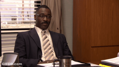 Man In Suit At Desk By Window With Blinds GIF