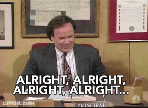 Man In Suit At Desk Saying Alright GIF