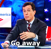 Man In Suit At Desk Saying Go Away GIF