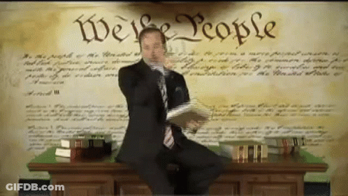 Man In Suit At Desk Saying We The People GIF