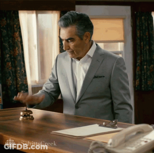 Man In Suit At Desk With Bell #Schitts Creek GIF