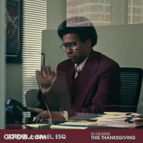 Man In Suit At Desk With Computer Saying Roman J. Israel Esq GIF