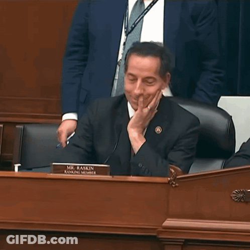 Man In Suit At Desk With Mr. Raskin Ranking Member Sign GIF