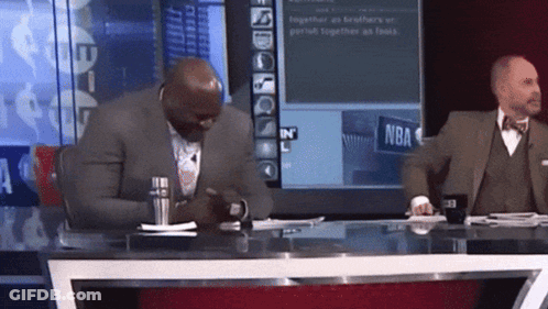 Man In Suit At Desk With NBA Screen GIF