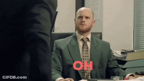 Man In Suit At Desk With Oh Written In Red GIF