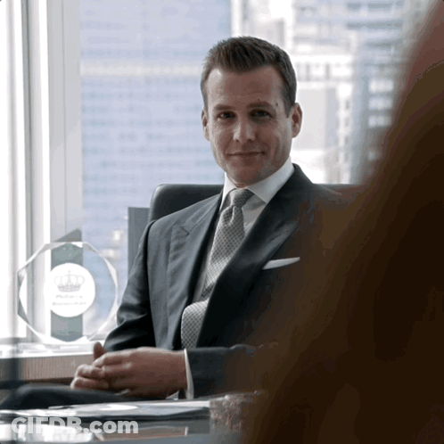 Man In Suit At Desk With Phillips Plaque GIF