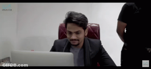 Man In Suit At Desk With Unlimited Laptop GIF