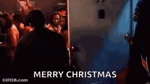 Man In Suit At Door In Crowded Room GIF