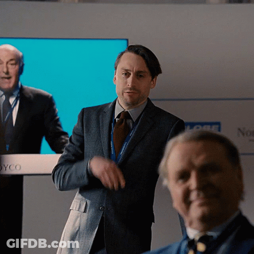 Man In Suit At Joyco Podium GIF