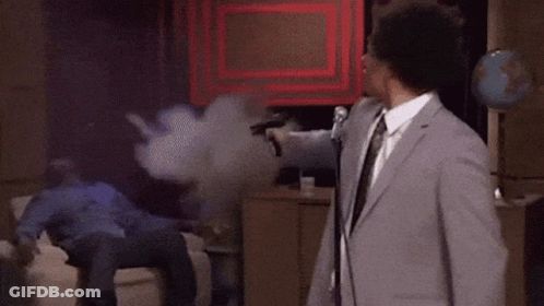 Man In Suit At Mic Man On Couch GIF