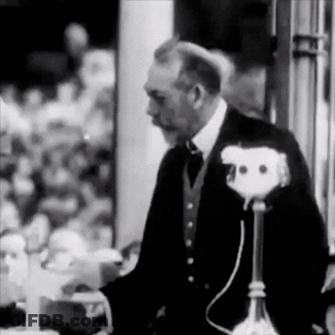 Man In Suit At Microphone GIF