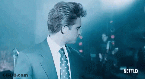 Man In Suit At Microphone In Dark Room GIF